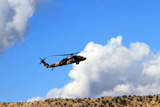  A Turkish military helicopter flies toward Iraq near Cukurca, Hakkari, Turkey, at the border with Iraq.