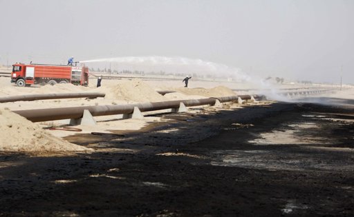  Firefighters spray water over a damaged oil pipeline a day after a bomb attack occurred in Rumaila oilfield in Basra.
