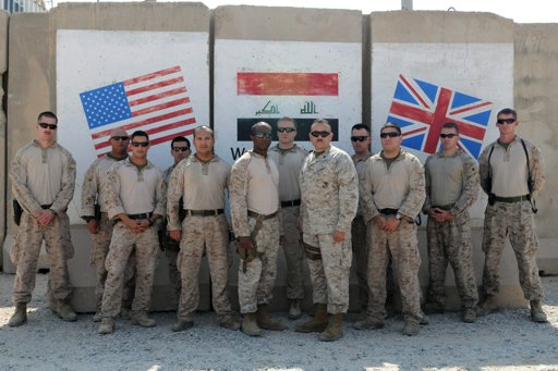  A team of 13 U.S. Marine Corps trainers assigned to the Iraqi Marine Training Team 03 gather for a photo as the last Marine team of Operation New Dawn to leave Iraq, in Umm Qasr.
