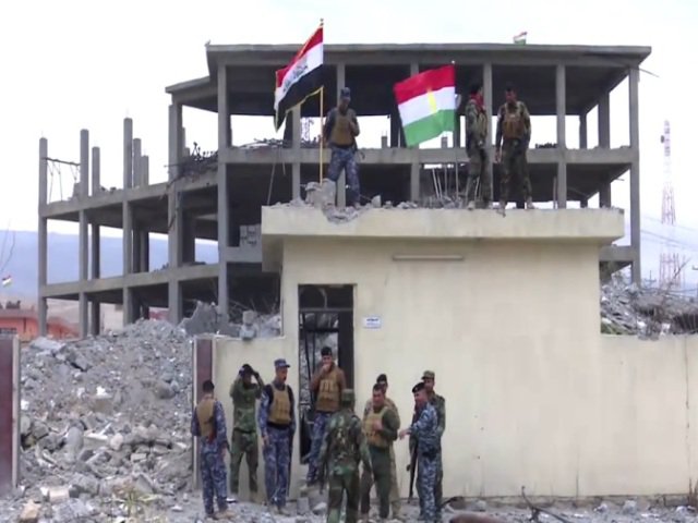  Security forces raise Iraqi flag over devastated building of Sinjar Council