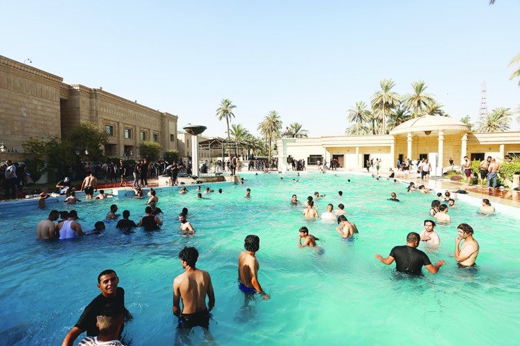 Protesters jump in Presidential Palace swimming pool to face Iraq’s hot weather