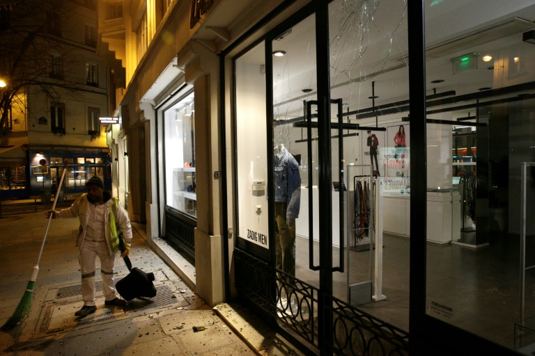  French climate activists target store lights in Paris night raids