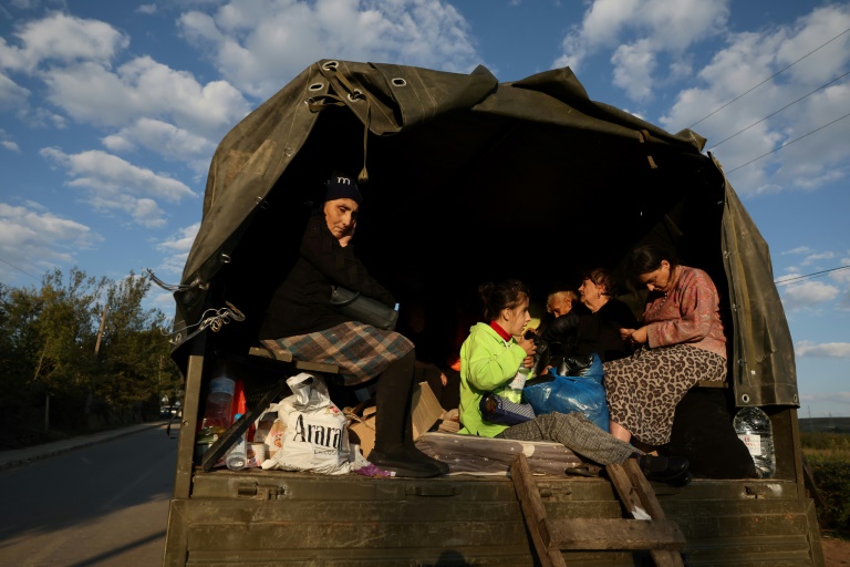  Karabakh refugees burn cherished possessions on way out
