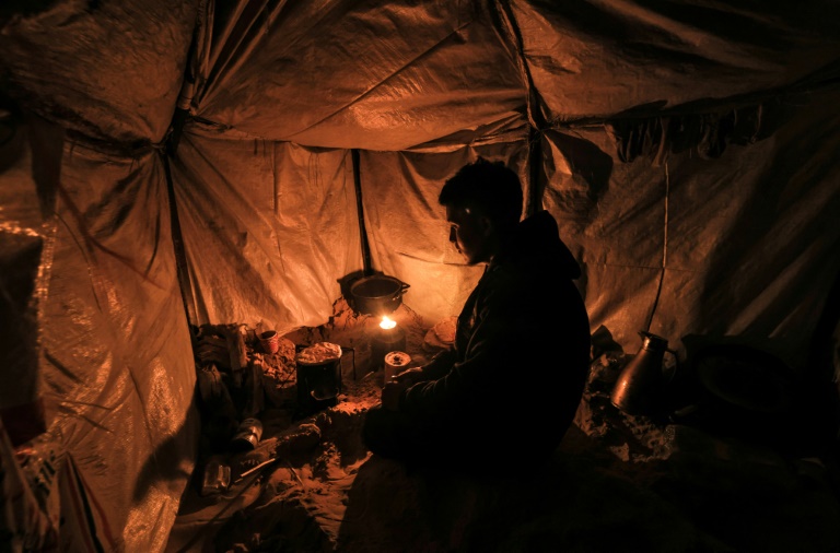  Freezing in makeshift tents, Gazans burn plastic to survive